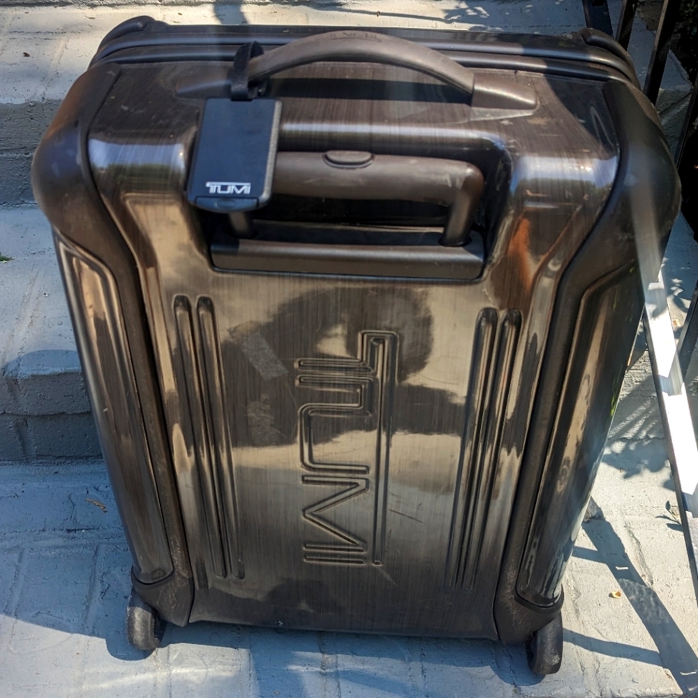 TUMI hard shell carry-on luggage